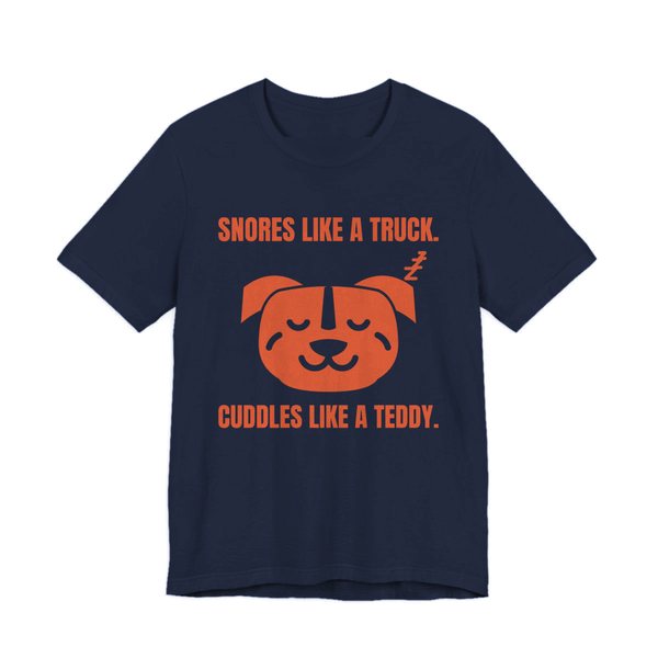 Navy t-shirt printed in orange ink with a sleeping pit bull face and the words “Snores Like a Truck. Cuddles Like a Teddy.”