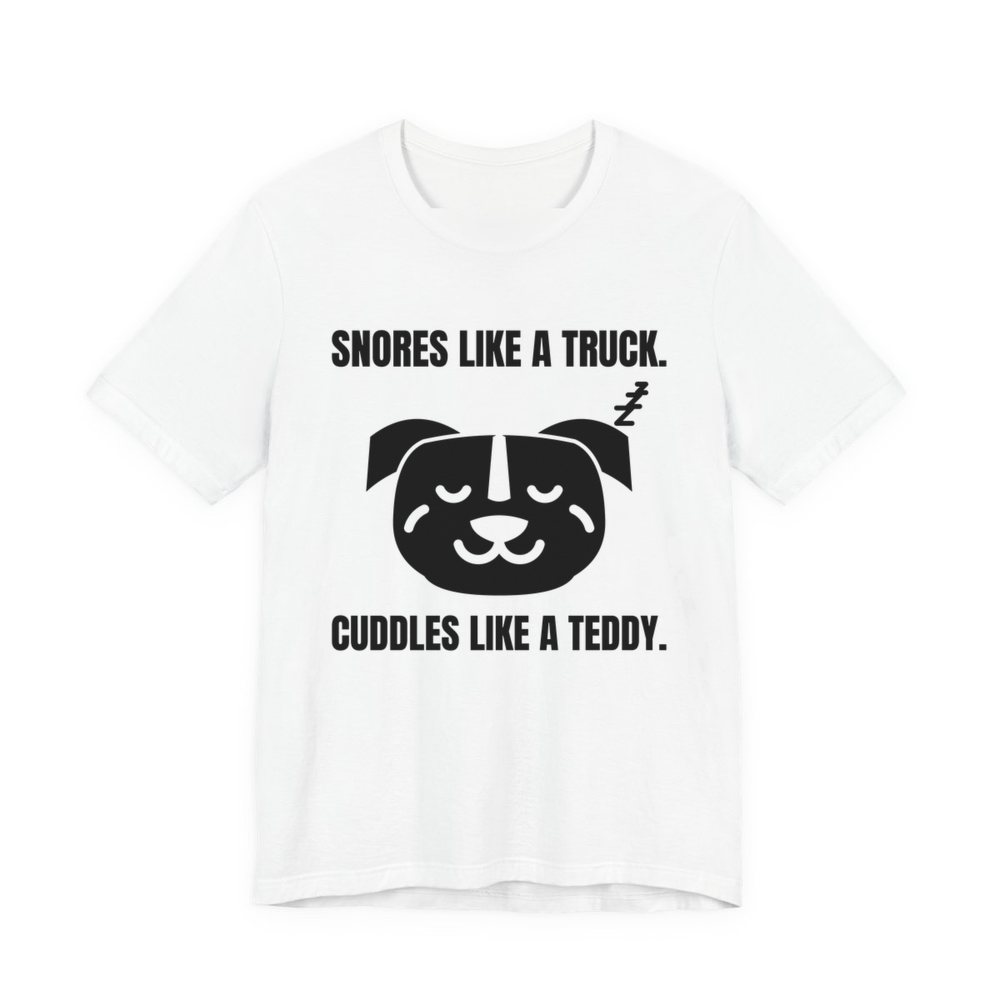 White t-shirt printed in dark ink with a sleeping pit bull face and the words “Snores Like a Truck. Cuddles Like a Teddy.”