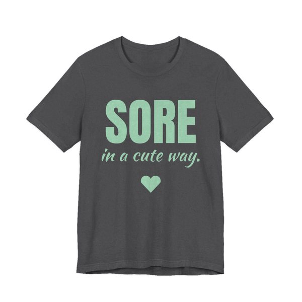 Dark Grey Heather t-shirt printed in mint green ink with a heart and the words "Sore in a Cute Way."
