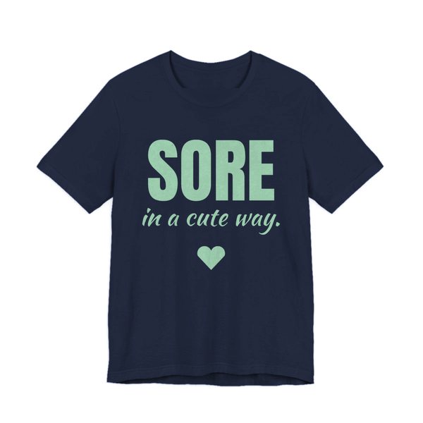 Navy t-shirt printed in mint green ink with a heart and the words "Sore in a Cute Way."