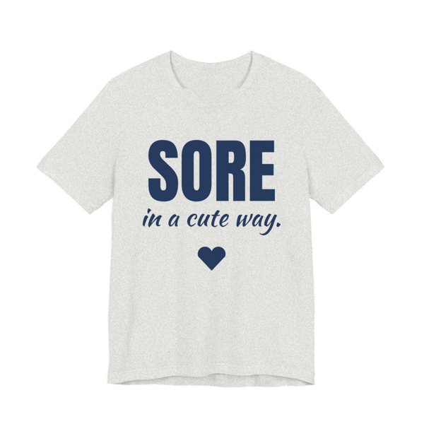 Ash t-shirt printed in navy blue ink with a heart and the words "Sore in a Cute Way."