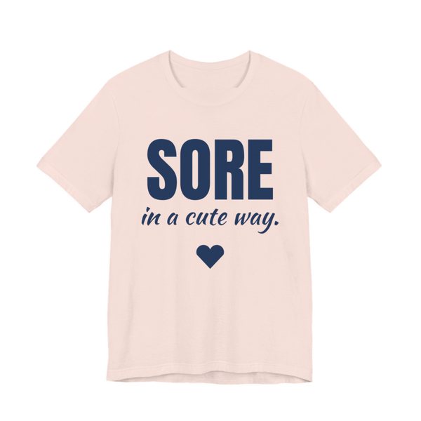 Soft Pink t-shirt printed in navy blue ink with a heart and the words "Sore in a Cute Way."