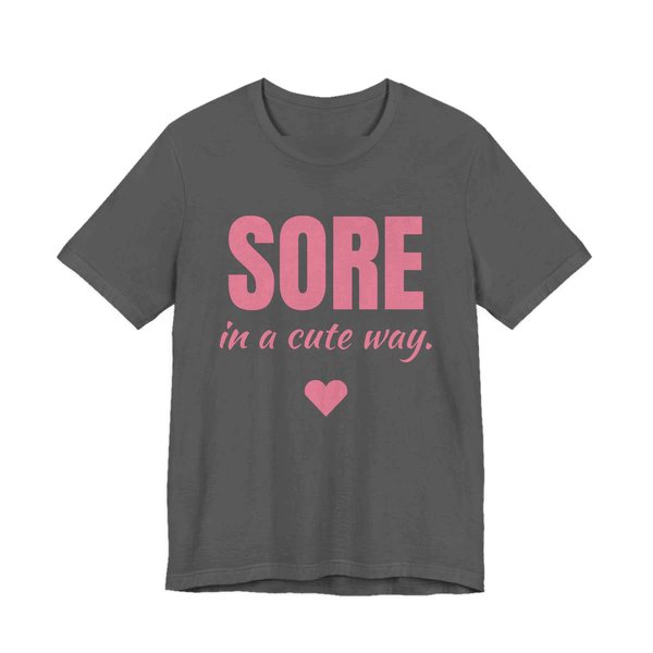 Asphalt t-shirt printed in rose pink ink with a heart and the words "Sore in a Cute Way."