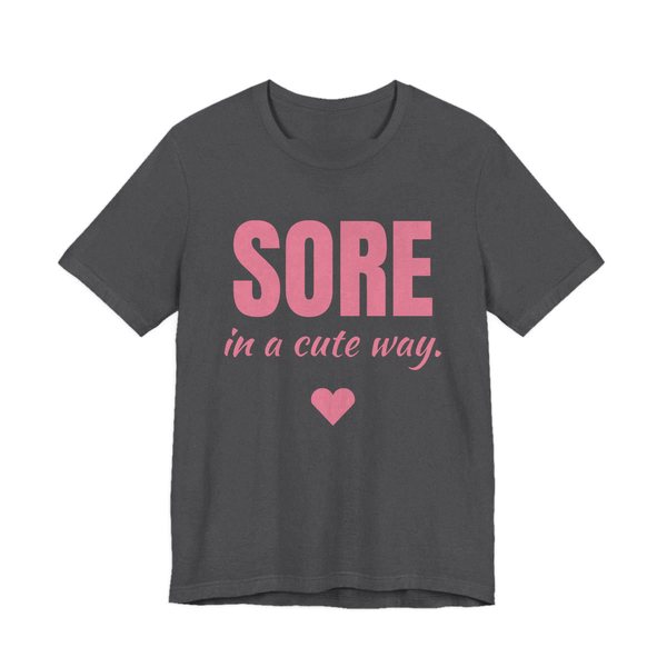 Dark Grey Heather t-shirt printed in rose pink ink with a heart and the words "Sore in a Cute Way."