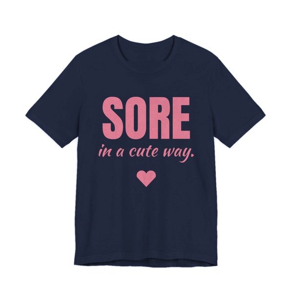 Navy t-shirt printed in rose pink ink with a heart and the words "Sore in a Cute Way."