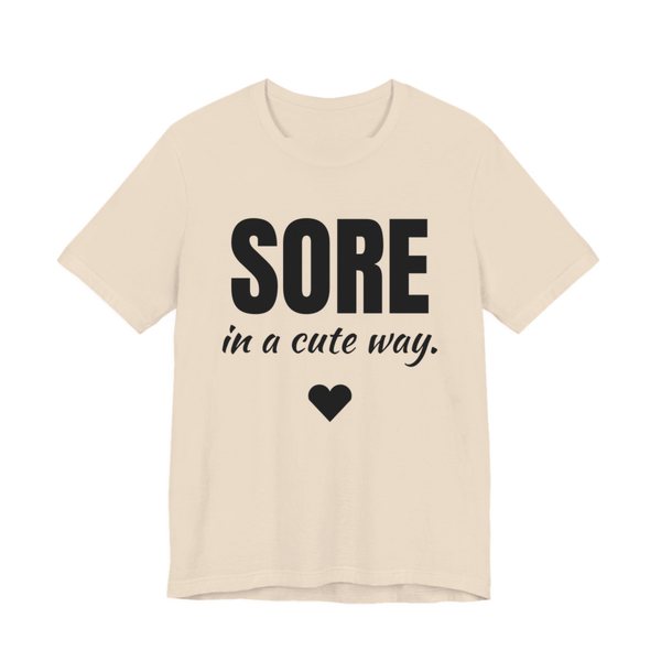 Soft Cream t-shirt printed in dark ink with a heart and the words "Sore in a Cute Way."