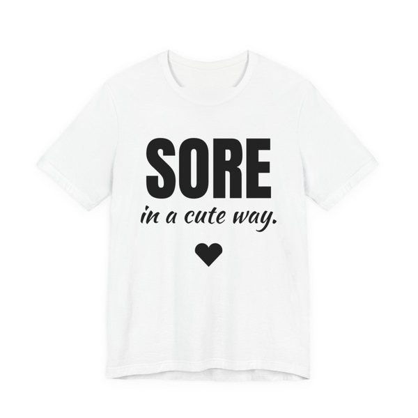 White t-shirt printed in dark ink with a heart and the words "Sore in a Cute Way."