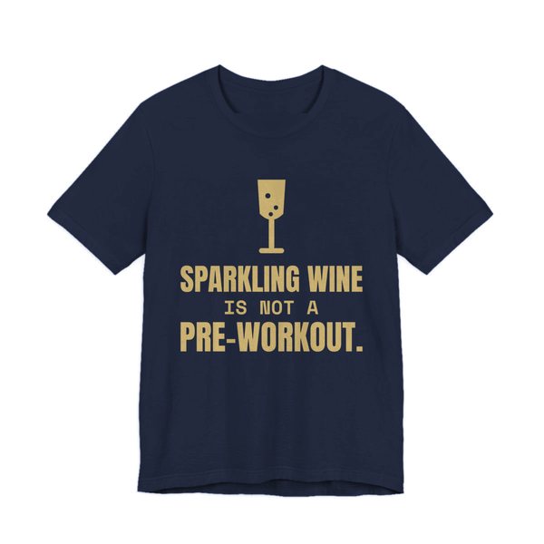 Navy t-shirt printed in champagne gold ink with a glass of sparkling wine and the words “Sparkling Wine Is Not a Pre-Workout.”
