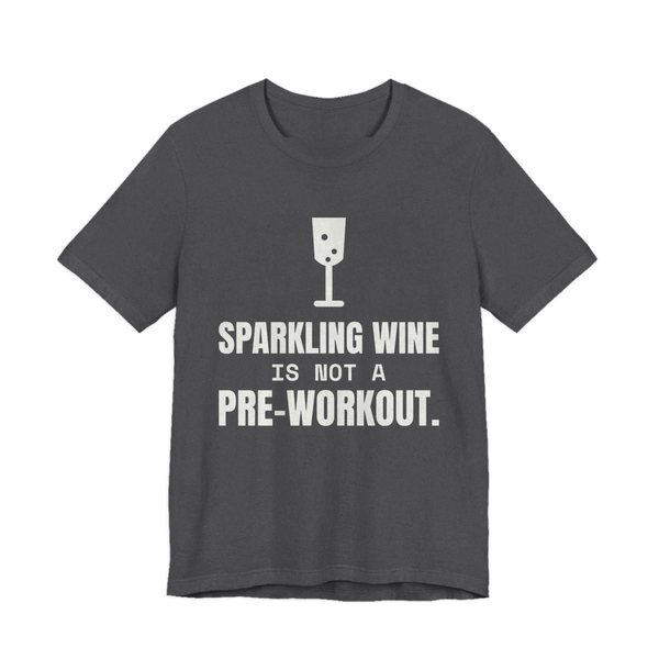 Dark Grey Heather t-shirt printed in off-white ink with a glass of sparkling wine and the words “Sparkling Wine Is Not a Pre-Workout.”