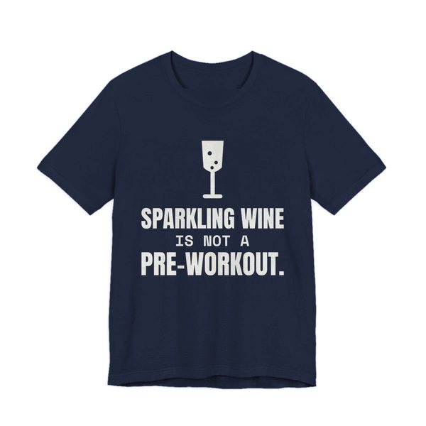 Navy t-shirt printed in off-white ink with a glass of sparkling wine and the words “Sparkling Wine Is Not a Pre-Workout.”