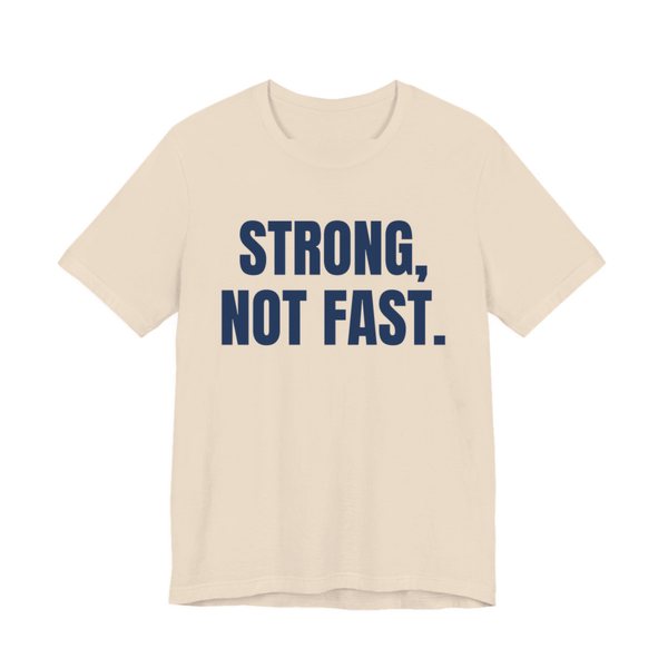 Soft Cream t-shirt printed in navy blue ink with the words "Strong, Not Fast."