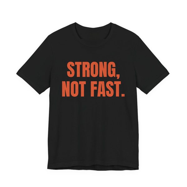 Black t-shirt printed in orange ink with the words "Strong, Not Fast."