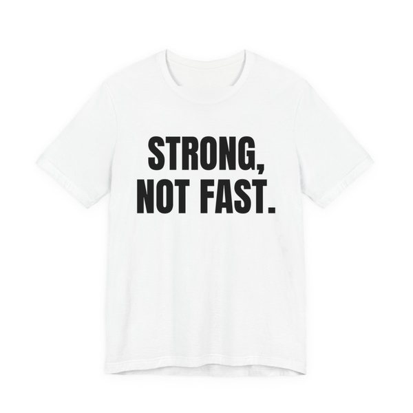 White t-shirt printed in dark ink with the words "Strong, Not Fast."