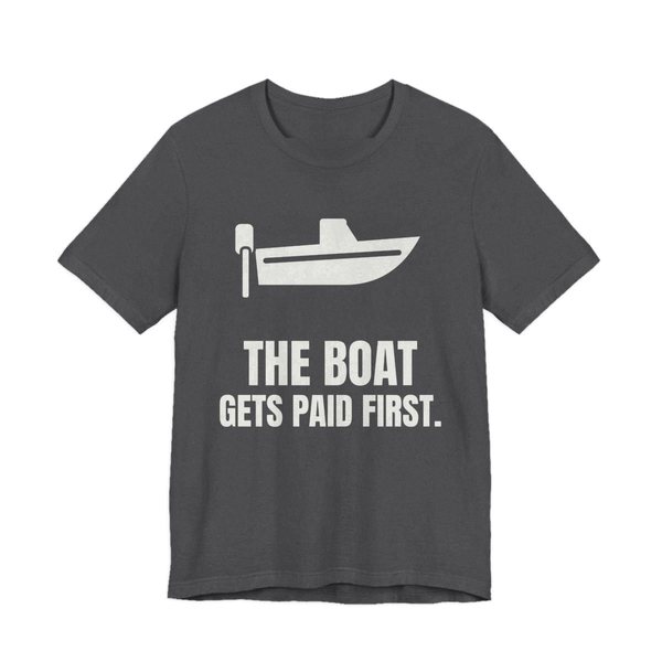 Dark Grey Heather t-shirt printed in off-white ink with a boat with an outboard motor and the words “The Boat Gets Paid First.”