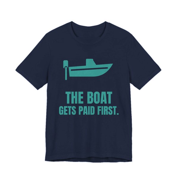 Navy t-shirt printed in teal ink with a boat with an outboard motor and the words “The Boat Gets Paid First.”