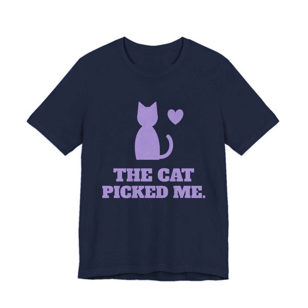 Navy t-shirt printed in lavender ink with a sitting cat with a heart and the words “The Cat Picked Me.”