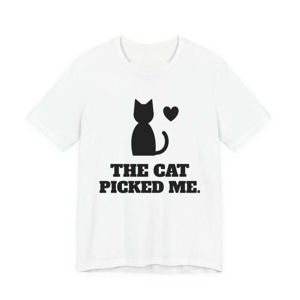 White t-shirt printed in dark ink with a sitting cat with a heart and the words “The Cat Picked Me.”