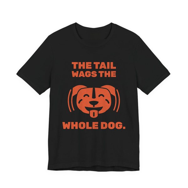 Black t-shirt printed in orange ink with a wiggling pit bull face and the words “The Tail Wags the Whole Dog.”