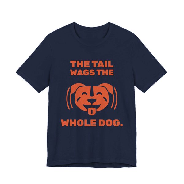 Navy t-shirt printed in orange ink with a wiggling pit bull face and the words “The Tail Wags the Whole Dog.”