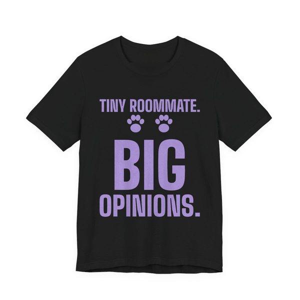 Black t-shirt printed in lavender ink with paw prints and the words “Tiny Roommate. Big Opinions.”
