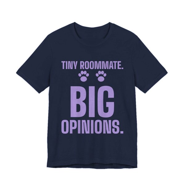 Navy t-shirt printed in lavender ink with paw prints and the words “Tiny Roommate. Big Opinions.”