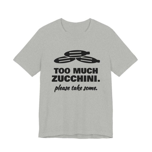 Athletic Heather t-shirt printed in dark ink with a pile of zucchini and the words “Too Much Zucchini. Please Take Some.”
