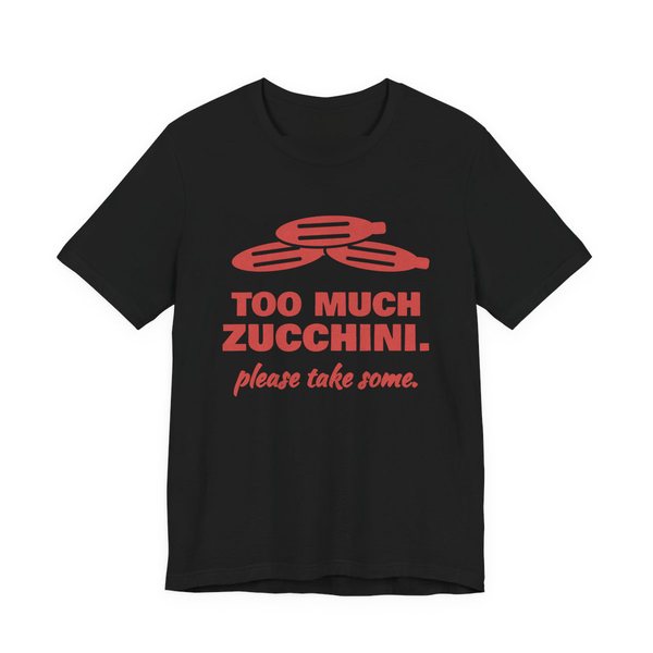Black t-shirt printed in tomato red ink with a pile of zucchini and the words “Too Much Zucchini. Please Take Some.”