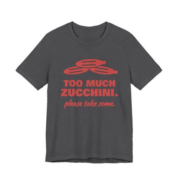 Dark Grey Heather t-shirt printed in tomato red ink with a pile of zucchini and the words “Too Much Zucchini. Please Take Some.”