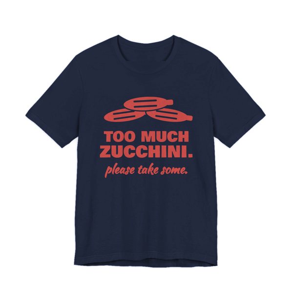Navy t-shirt printed in tomato red ink with a pile of zucchini and the words “Too Much Zucchini. Please Take Some.”