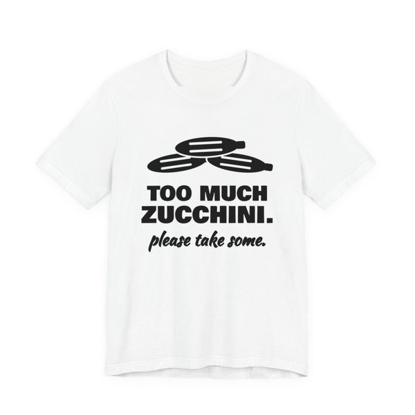 White t-shirt printed in dark ink with a pile of zucchini and the words “Too Much Zucchini. Please Take Some.”