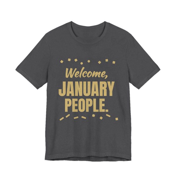 Dark Grey Heather t-shirt printed in champagne gold ink with confetti and the words “Welcome, January People.”