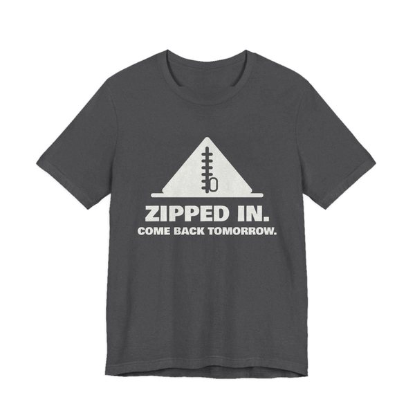 Dark Grey Heather t-shirt printed in off-white ink with a zipped-up tent and the words “Zipped In. Come Back Tomorrow.”