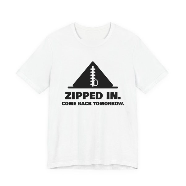 White t-shirt printed in dark ink with a zipped-up tent and the words “Zipped In. Come Back Tomorrow.”
