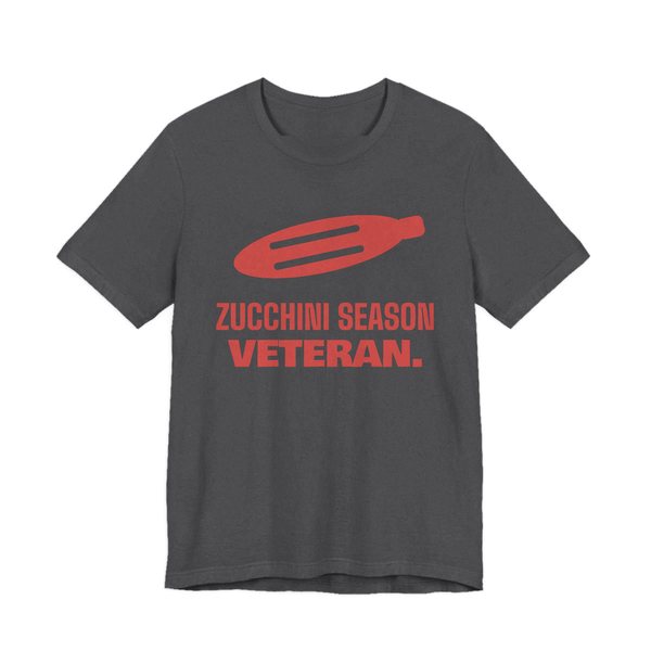 Dark Grey Heather t-shirt printed in tomato red ink with a big zucchini and the words “Zucchini Season Veteran.”