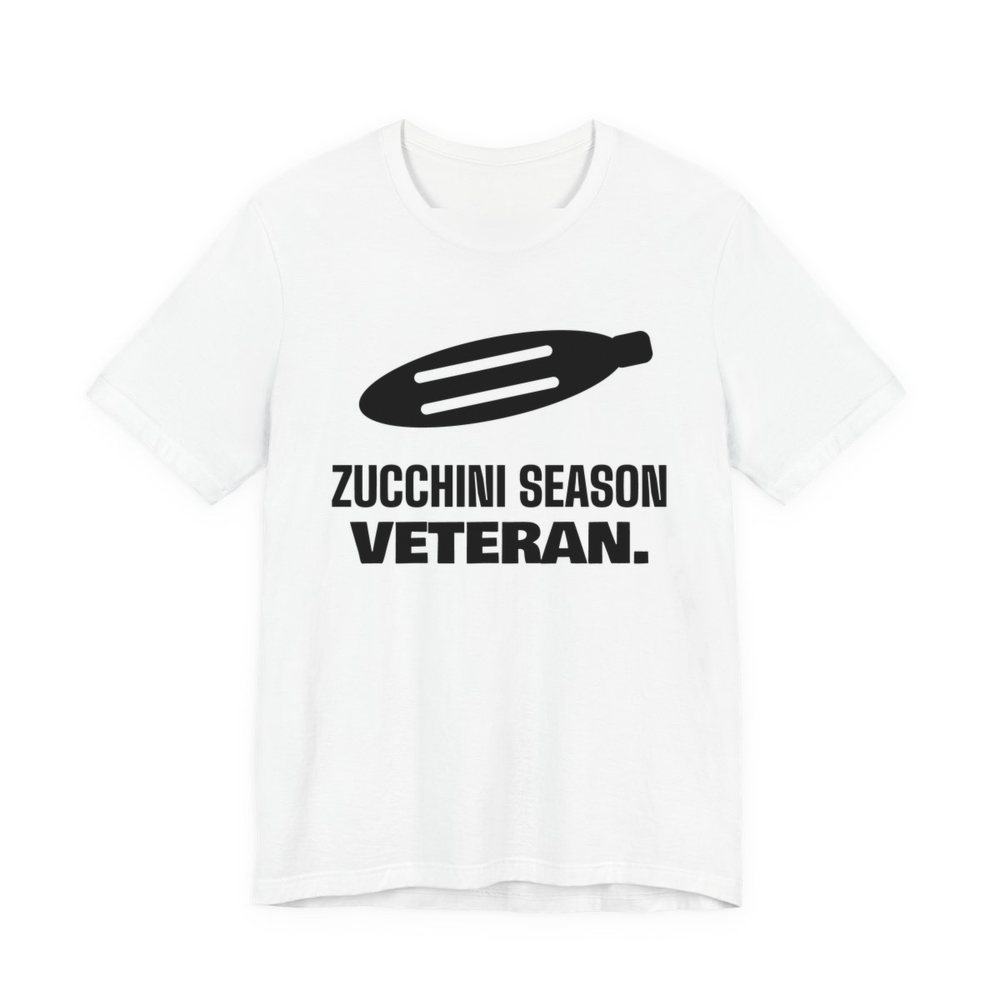 White t-shirt printed in dark ink with a big zucchini and the words “Zucchini Season Veteran.”